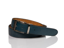 Load image into Gallery viewer, Hand made blue leather belts  The ZapatoSanchez monogram is imprinted in its metalic buckle matching the blue leather in this belt introduced for Spring 2021. The blue stitching completes the accessory.  Blue supreme blue leather with a tan coloured lining Metalic-toned hardware Belts are 1.5 inches wide and are measured from the end of the buckle to the center hole. Sizing may differ based on where the belt is worn (at the hips vs on the waist)  1.3/8 inches. Made in Canada
