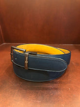 Load image into Gallery viewer, Hand made blue leather belts The ZapatoSanchez monogram is imprinted in its metalic buckle matching the blue leather in this belt introduced for Spring 2021. The blue stitching completes the accessory. Blue supreme blue leather with a tan coloured lining Metalic-toned hardware Belts are 1.5 inches wide and are measured from the end of the buckle to the center hole. Sizing may differ based on where the belt is worn (at the hips vs on the waist) 1.3/8 inches. Made in Canada
