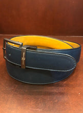 Load image into Gallery viewer, Hand made blue leather belts The ZapatoSanchez monogram is imprinted in its metalic buckle matching the blue leather in this belt introduced for Spring 2021. The blue stitching completes the accessory. Blue supreme blue leather with a tan coloured lining Metalic-toned hardware Belts are 1.5 inches wide and are measured from the end of the buckle to the center hole. Sizing may differ based on where the belt is worn (at the hips vs on the waist) 1.3/8 inches. Made in Canada
